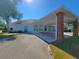 Exterior view of the community clubhouse with a covered entryway and well-maintained landscaping at 13155 Cori Loop, Spring Hill, FL 34609