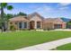 Attractive single-story home with a lush green lawn and well-maintained landscaping creates a charming curb appeal at 13155 Cori Loop, Spring Hill, FL 34609