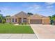 Charming single-story home featuring a well-maintained lawn and a spacious two-car garage at 13155 Cori Loop, Spring Hill, FL 34609
