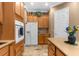 Bright kitchen boasts stainless steel appliances, light wood cabinetry, and tiled floors at 13155 Cori Loop, Spring Hill, FL 34609