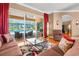 Comfortable living room with a view of the pool, featuring a modern glass table and stylish decor at 13155 Cori Loop, Spring Hill, FL 34609