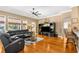 Living room with hardwood floors, a large sectional sofa, and a ceiling fan at 13155 Cori Loop, Spring Hill, FL 34609