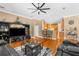 Spacious living room with hardwood floors, ceiling fan, and open layout to kitchen at 13155 Cori Loop, Spring Hill, FL 34609