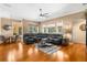 Open-concept living room with hardwood floors and a large sectional at 13155 Cori Loop, Spring Hill, FL 34609