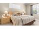 Relaxing main bedroom offers neutral tones, natural lighting, and ceiling fan at 13155 Cori Loop, Spring Hill, FL 34609