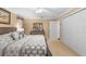 Comfortable carpeted bedroom featuring a full-size bed, ceiling fan, closet, and dresser at 13155 Cori Loop, Spring Hill, FL 34609