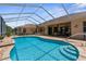 Beautiful screened-in pool with brick pavers and seamless access to the home, perfect for entertainment at 13155 Cori Loop, Spring Hill, FL 34609