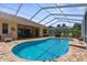Stunning view of a sparkling pool within a screened enclosure, complete with an outdoor patio at 13155 Cori Loop, Spring Hill, FL 34609