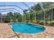 A beautiful pool with a screened enclosure and brick pavers, perfect for outdoor relaxation and entertaining at 13155 Cori Loop, Spring Hill, FL 34609