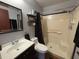 Bathroom with shower, toilet, sink, and mirror at 13180 Lawrence St, Spring Hill, FL 34609