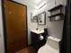 Bathroom featuring a toilet, sink, and mirror at 13180 Lawrence St, Spring Hill, FL 34609
