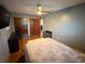 Cozy bedroom featuring ample natural light, laminate wood flooring, and ample closet space at 13180 Lawrence St, Spring Hill, FL 34609