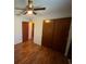 Bedroom featuring a ceiling fan, wood floors, and closet at 13180 Lawrence St, Spring Hill, FL 34609