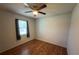 Bedroom featuring a ceiling fan, wood floors, and window at 13180 Lawrence St, Spring Hill, FL 34609