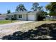 Charming single-story home featuring a well-manicured lawn and a one car attached garage at 13180 Lawrence St, Spring Hill, FL 34609