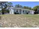 Charming single-story home with a well-manicured front yard and adjacent chain link fence at 13180 Lawrence St, Spring Hill, FL 34609