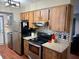 Kitchen with stainless steel refrigerator and updated oven and range at 13180 Lawrence St, Spring Hill, FL 34609