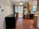 Bright kitchen and dining area with updated wooden cabinetry, stainless steel appliances, and backyard access at 13180 Lawrence St, Spring Hill, FL 34609
