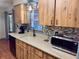 Kitchen featuring wood cabinets and updated counters, sink, and microwave at 13180 Lawrence St, Spring Hill, FL 34609