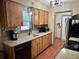 Charming kitchen featuring wood cabinets, modern appliances, and backsplash at 13180 Lawrence St, Spring Hill, FL 34609