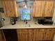Kitchen featuring wood cabinets and updated counters, sink, and appliances at 13180 Lawrence St, Spring Hill, FL 34609