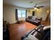 Spacious living room with hardwood floors, ceiling fan, and comfortable leather sofa at 13180 Lawrence St, Spring Hill, FL 34609