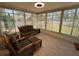 Sunroom with wicker furniture and large windows overlooking the yard at 13180 Lawrence St, Spring Hill, FL 34609