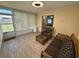 Bright sunroom with windows, wicker furniture, and tile floor at 13180 Lawrence St, Spring Hill, FL 34609