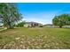 Extensive backyard with lush lawn, showcasing the home's back facade and a serene outdoor environment at 13317 Pinellas Ave, Spring Hill, FL 34609