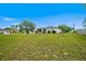 Spacious backyard offering lush green space, highlighting the home's screened patio and outdoor potential at 13317 Pinellas Ave, Spring Hill, FL 34609