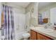 Cozy bathroom features a tub and shower combination with white tiling and neutral decor at 13317 Pinellas Ave, Spring Hill, FL 34609