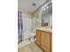 Cozy bathroom features a tub and shower combination with white tiling and neutral decor at 13317 Pinellas Ave, Spring Hill, FL 34609