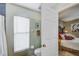 Bathroom with toilet, window, and doorway to bedroom at 13317 Pinellas Ave, Spring Hill, FL 34609