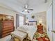 Cozy bedroom featuring a ceiling fan, large window and decor at 13317 Pinellas Ave, Spring Hill, FL 34609