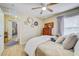 Comfortable bedroom featuring a ceiling fan, wood-look floors, and natural light from the window at 13317 Pinellas Ave, Spring Hill, FL 34609