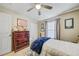 Cozy bedroom with a ceiling fan, closet, window, and dresser at 13317 Pinellas Ave, Spring Hill, FL 34609