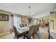 Elegant dining room with a large table, chandelier, and ample natural light at 13317 Pinellas Ave, Spring Hill, FL 34609
