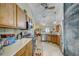 Open kitchen with wooden cabinets, modern stainless steel appliances and eat-in breakfast area at 13317 Pinellas Ave, Spring Hill, FL 34609
