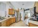 Spacious kitchen featuring wooden cabinets, stainless appliances and an adjacent dining area at 13317 Pinellas Ave, Spring Hill, FL 34609