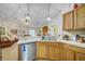 Spacious kitchen boasts wooden cabinets, stainless steel appliances, and a view of the living area at 13317 Pinellas Ave, Spring Hill, FL 34609