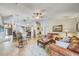 Inviting living room with comfortable leather furniture, ceiling fan and an open floor plan at 13317 Pinellas Ave, Spring Hill, FL 34609