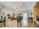 Open-concept living room showcasing tile floors, leather furniture, and plenty of natural light at 13317 Pinellas Ave, Spring Hill, FL 34609