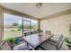 Enclosed patio featuring comfortable seating and an outdoor dining area, great for entertaining guests at 13317 Pinellas Ave, Spring Hill, FL 34609