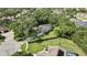 Wide aerial view of a secluded home with mature landscaping, long driveway, and generous lot at 13460 Pia Ct, Spring Hill, FL 34609
