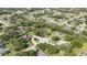 Expansive aerial view of a neighborhood showcasing lush greenery and single-Gathering homes with well-maintained lawns at 13460 Pia Ct, Spring Hill, FL 34609