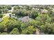 Aerial image highlights home with a pool, mature trees, and generous outdoor space at 13460 Pia Ct, Spring Hill, FL 34609