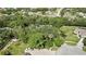 A bird's eye view of the residence surrounded by mature trees and ample yard space at 13460 Pia Ct, Spring Hill, FL 34609