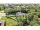 Spacious property featuring a home, screened pool, and mature landscaping from an aerial perspective at 13460 Pia Ct, Spring Hill, FL 34609