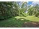 Large backyard with lush landscaping offers privacy and a serene outdoor space at 13460 Pia Ct, Spring Hill, FL 34609