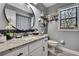 Well-lit bathroom with a decorative stained-glass window, decorative shelf, granite countertop, and round mirror at 13460 Pia Ct, Spring Hill, FL 34609